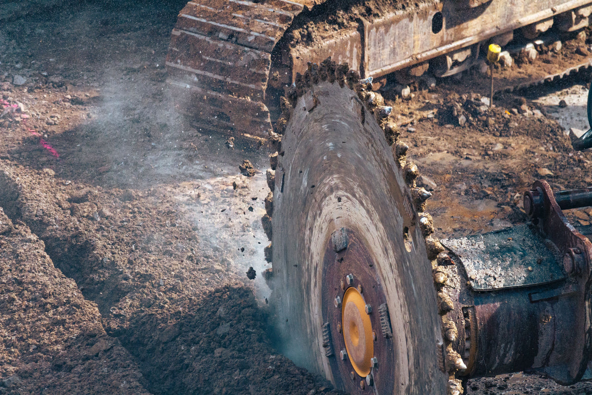 Trencher teeth cutting through earth