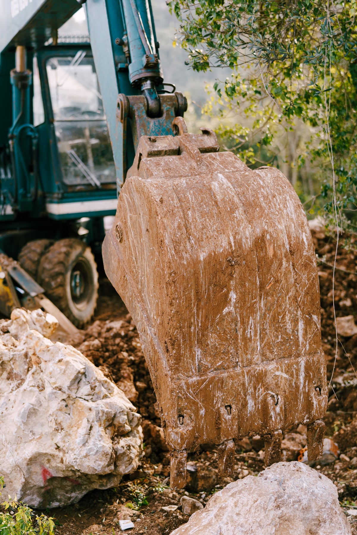 Excavator bucket with cutting edge at a construction site