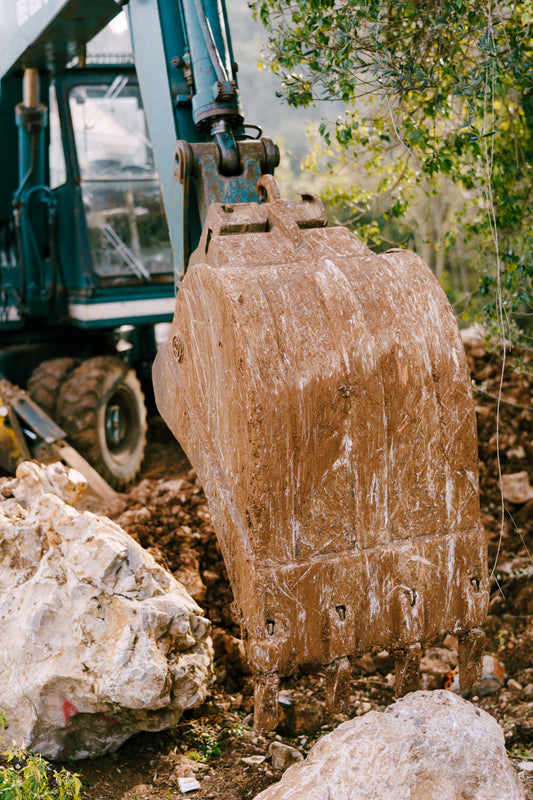 Excavator bucket with cutting edge at a construction site