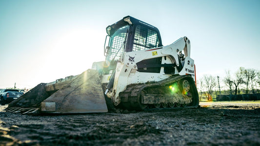 PLACEHOLDER - skid steer loader on a construction site in bright sun